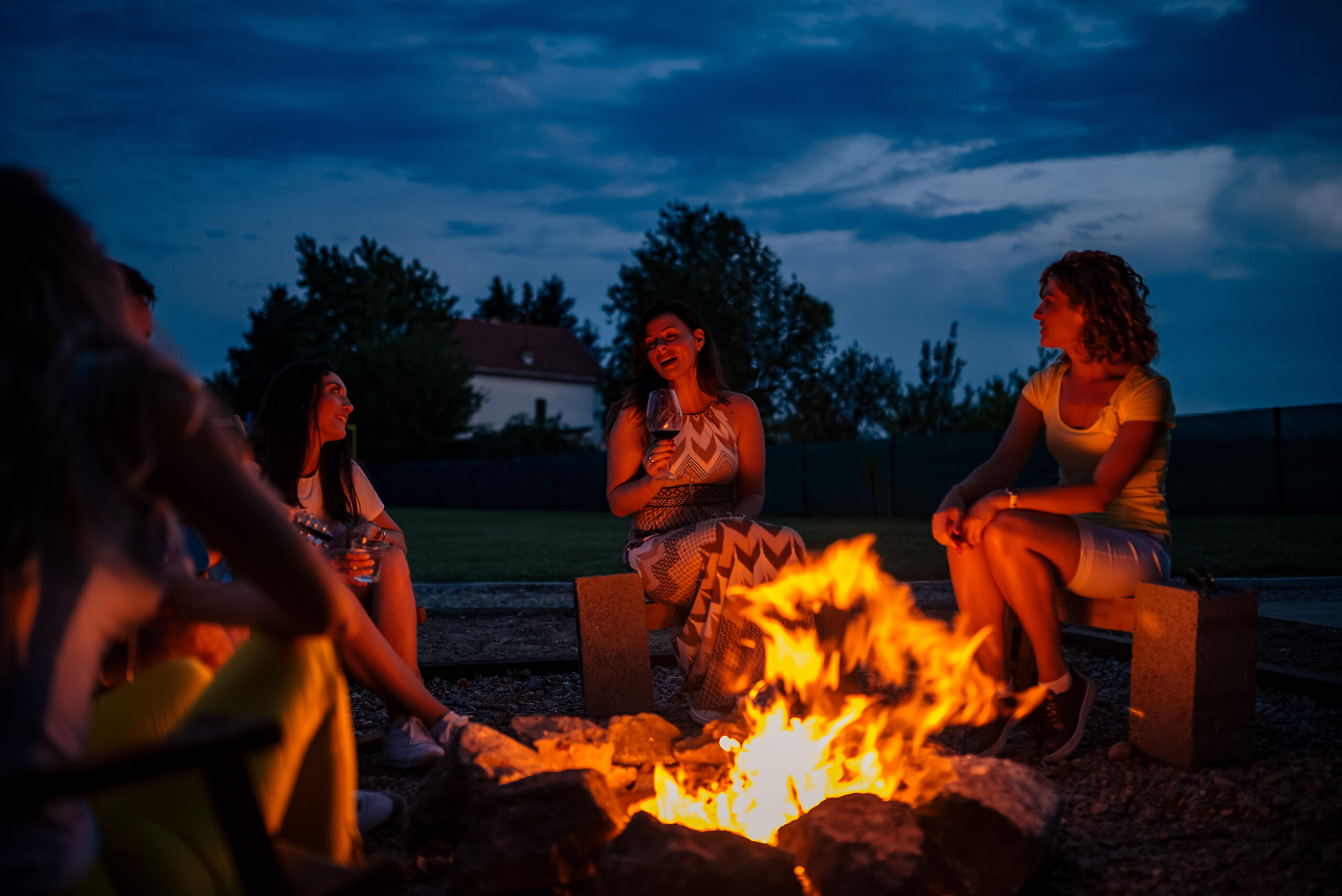 A group of people sitting around a fire.